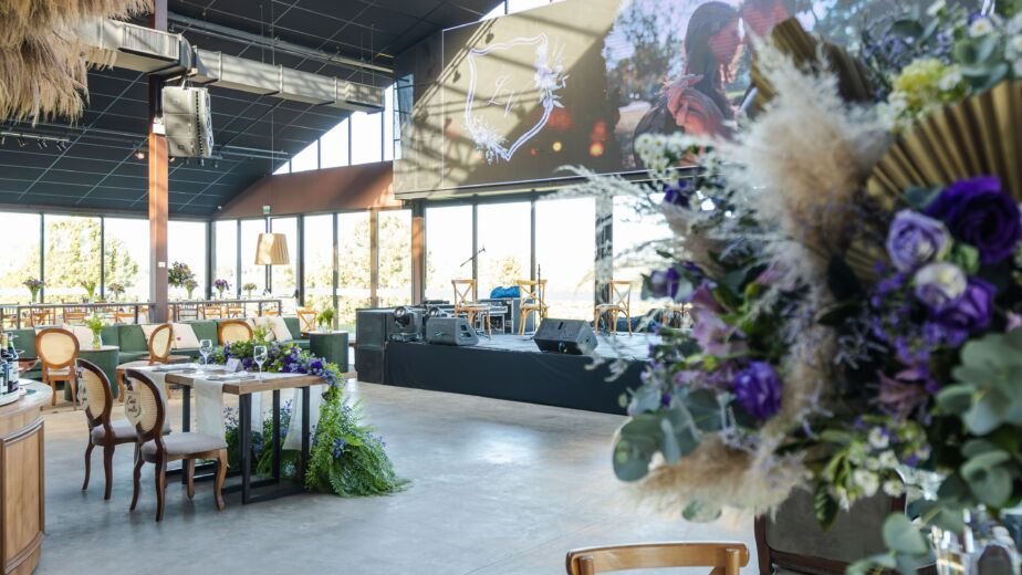 Elegant luxury banquet hall decorated for a reception with chandeliers and floral centerpieces