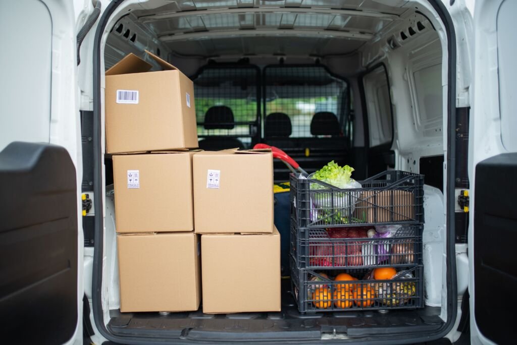 Delivery van loaded with fresh produce crates for food distribution