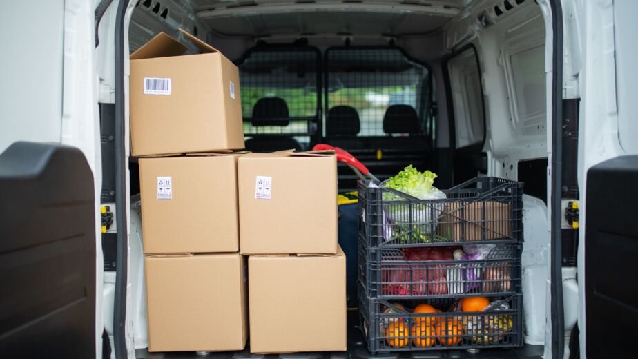 Delivery van loaded with fresh produce crates for food distribution